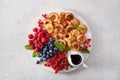 American mini pancake board with berries and maple syrup