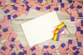 American mini and Pride Flags lie on a wooden background, top view, template for invitations and posters. Acceptance symbol. space