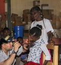 American missionary doctor examines a sick young girl in rural Haiti. during a clinic in rural Haiti.