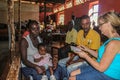 American missionary nurse practitioner meets with Haitian woman and girl assisted