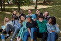 American mixed race youth sit on grass together and have fun