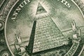 American money, illuminati and mystical symbols concept with macro close up on the all seeing eyeball atop the pyramid on the back Royalty Free Stock Photo