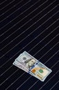 American money on solar panel surface. Renewable energy cost Royalty Free Stock Photo