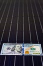 American money on solar panel surface. Renewable energy cost Royalty Free Stock Photo