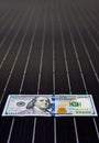 American money on solar panel surface. Renewable energy cost Royalty Free Stock Photo