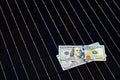 American money on solar panel surface. Renewable energy cost Royalty Free Stock Photo