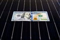 American money on solar panel surface. Renewable energy cost Royalty Free Stock Photo