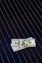 American money on solar panel surface. Renewable energy cost Royalty Free Stock Photo