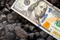 American money sticking out of a pile of coal, 100 dollar banknote, US mining concept, Rising coal prices, Environmental impact,