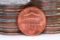 American one cent coin against quarter coins Royalty Free Stock Photo