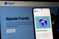 American open-source, encrypted messaging service Signal app on mobile app in front of desktop version