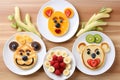 American pancakes decorated like smile and happy faces with strawberries, chocolate, blueberries and banana. Food for kids,