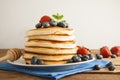 American pancakes or fritters served with strawberry and blueberry jam, delicious dessert for breakfast, rustic style, wooden back Royalty Free Stock Photo