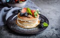 American pancakes with whipped cream, strawberries, blackberries, walnuts and powdered sugar Royalty Free Stock Photo