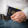 American passport with documents in the hand of a man. Passport, plane tickets and car rental documents Royalty Free Stock Photo