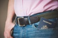 American passport in jeans pocket. The young man is preparing for the journey. Waiting for a flight at the airport at customs or