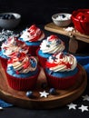 American patriotic cupcakes with cherries and stars on dark background. generated ai Royalty Free Stock Photo