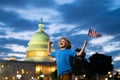 American Patriotic holiday. American kid, cute little child boy with American flag near Capitol building in Washington Royalty Free Stock Photo