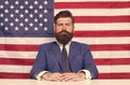 American patriotism. American citizen in formalwear. Bearded man on american flag background. Independence day. July 4th