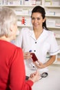 American pharmacist dispensing to senior woman Royalty Free Stock Photo