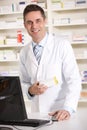 American pharmacist working on computer