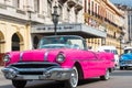 American pink convertible Pontiac classic car drive with tourists through Havana Cuba - Serie Cuba Reportage Royalty Free Stock Photo