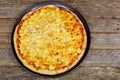 American pizza with pepperoni, mozzarella and tomato sauce. Pizza on a wooden table,