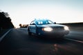 American Police Car driving on the Street. Mode of Transportation in fast action at night.