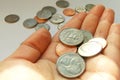 American quarter, dime coins in hand on dollar usa background Royalty Free Stock Photo