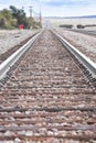 American railway with oak cross beams against a stone gravel (USA) Royalty Free Stock Photo