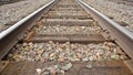 American railway with oak cross beams against a stone gravel (USA) Royalty Free Stock Photo