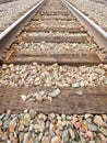 American railway with oak cross beams against a stone gravel (USA) Royalty Free Stock Photo