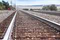 American railway with oak cross beams against a stone gravel Royalty Free Stock Photo