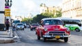 American red classic car in havana city on the street