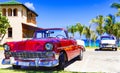 American red and blue white vintage car parked on the beach in Varadero Cuba - Serie Cuba Reportage