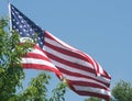 American Red, White and Blue Flag Waving Under beautiful blue sky` Royalty Free Stock Photo