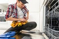 American Repairman Fixing Dishwasher Appliance Machine Royalty Free Stock Photo