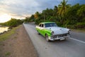 American retro car on a road with trees in background, Santiago de Cuba