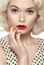 American retro. pin-up girl with old fashioned make-up, red nails manicure, blond hair Royalty Free Stock Photo