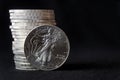An American Silver Eagle coin, against a stack of silver eagle coins Royalty Free Stock Photo