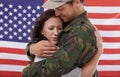 American soldier hug woman, reunion after war and welcome hero with love and flag. Army man reunite with partner Royalty Free Stock Photo