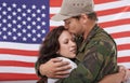 American soldier kiss woman, reunion after war and hug to welcome hero with love and flag. Army man reunite with partner Royalty Free Stock Photo