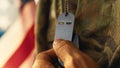 American soldier touches military tags