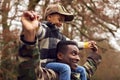 American Soldier In Uniform Returning Home To Family On Leave Carrying Son Wearing Army Cap Royalty Free Stock Photo