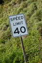 American speen imit sign with 40 mph against green hillside Royalty Free Stock Photo