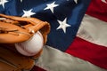 American sports and college athletics concept with the USA flag in the background and macro on a vintage baseball glove holding a Royalty Free Stock Photo