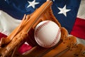 American sports and college athletics concept with the USA flag in the background and macro on a vintage baseball glove holding a Royalty Free Stock Photo