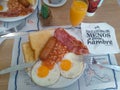 American style breakfast table set with egg squeezed beans and bacon
