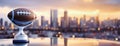 American Super Bowl Football Trophy Overlooking Urban Skyline at Twilight. A football trophy sits before a blurred Royalty Free Stock Photo