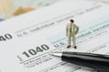 American tax calculation concept, miniature businessman standing